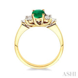 7x5mm Oval Cut Emerald and 1/3 Ctw Round Cut Diamond Ring in 14K Yellow Gold