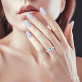 5x3 MM Oval Shape Blue Topaz and 1/20 Ctw Round Cut Diamond Halo Semi-Precious Ring in 10K White Gold