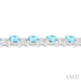 7x5 MM Oval Cut Blue Topaz and 1/20 Ctw Round Cut Diamond Fashion Bracelet in Sterling Silver